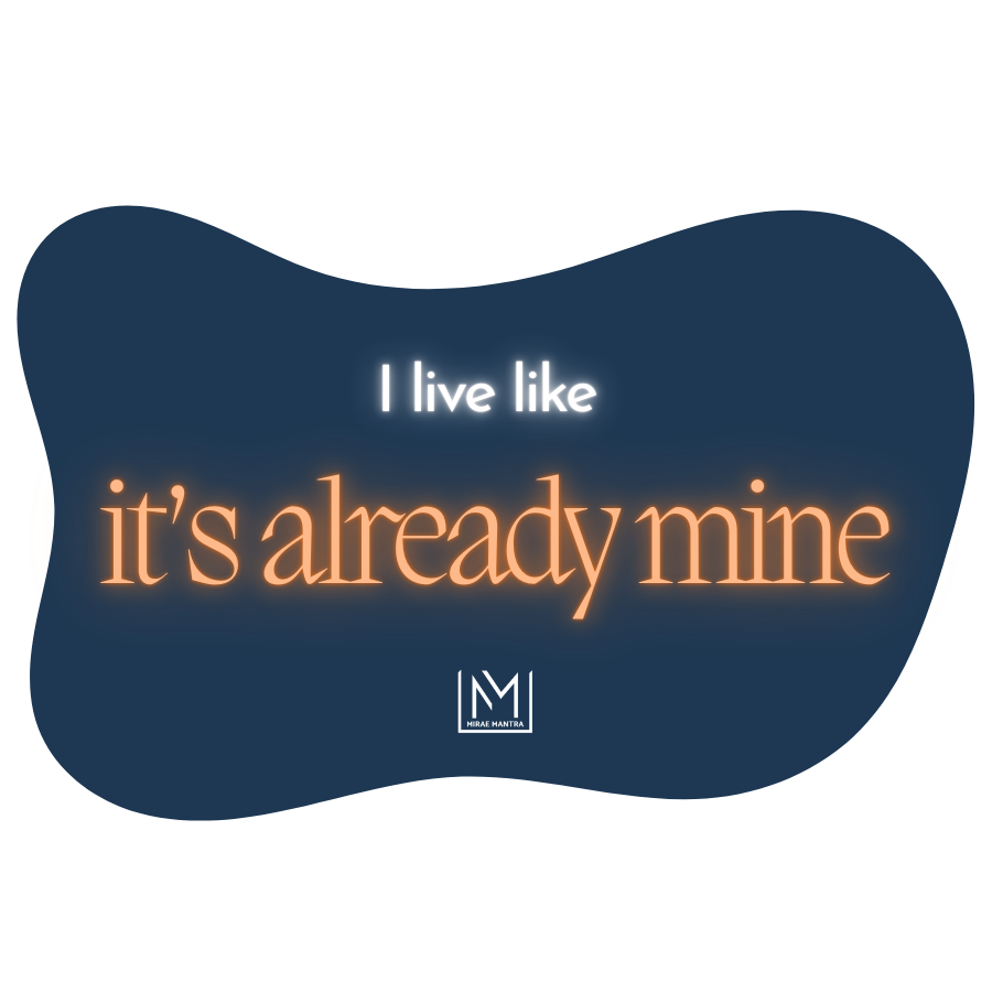 Navy blue background with orange text 'I live like it's already mine' and a logo on a white background. Mirae Mantra mirror affirmation sticker.