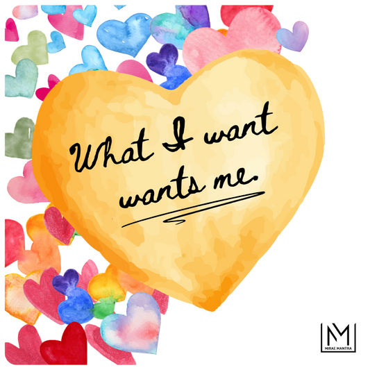 Heart-shaped yellow card with 'What I want wants me' text, surrounded by colorful watercolor hearts. Mirae Mantra mirror affirmation sticker.