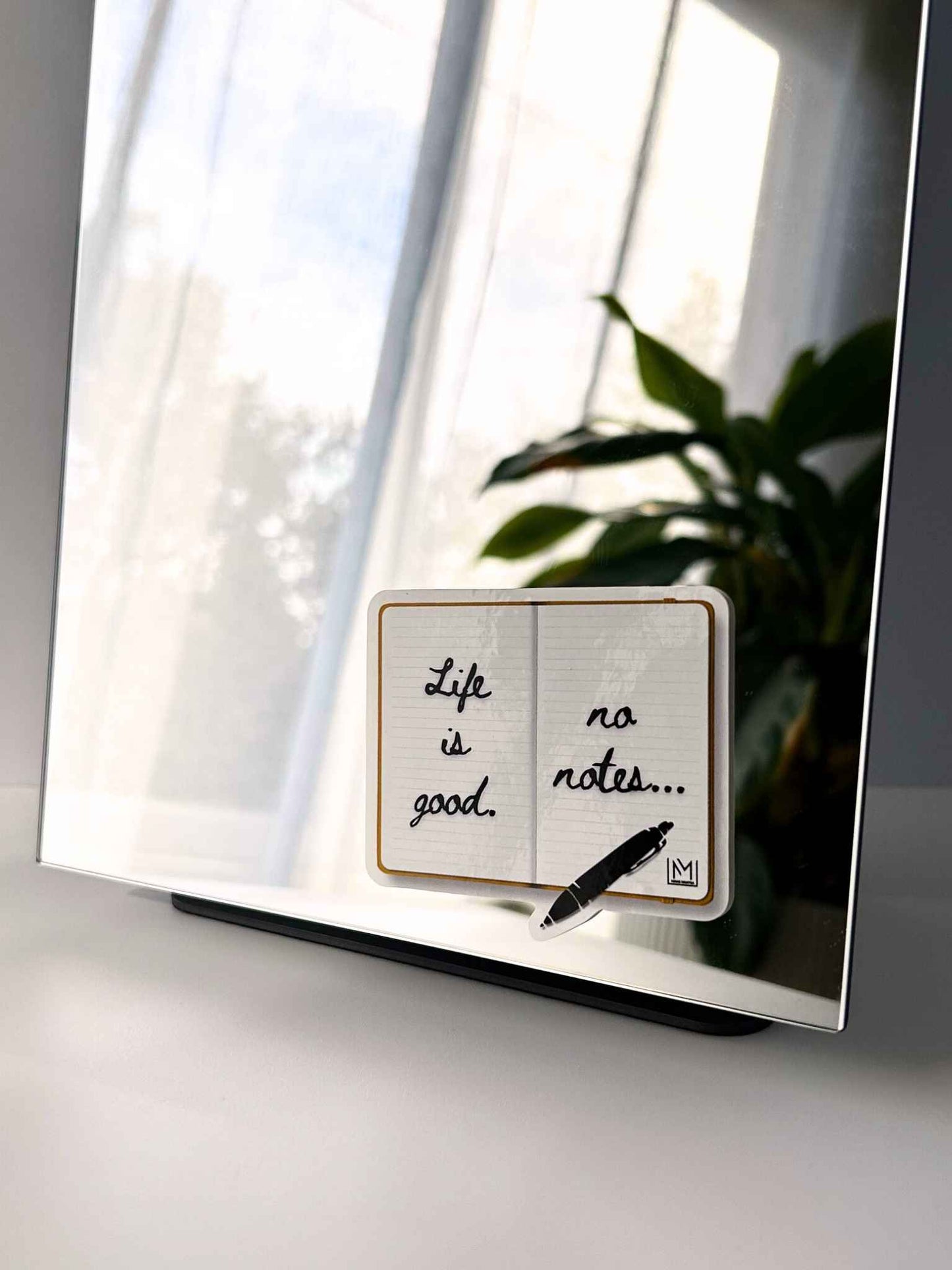 Positive mirror affirmation sticker featuring “Life is good, no notes” notebook design
