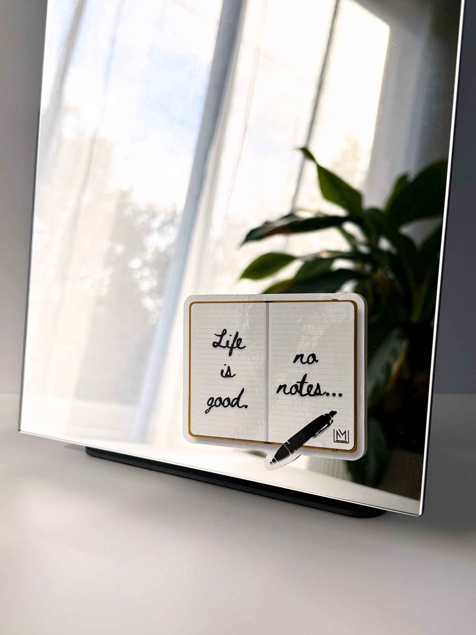 Positive mirror affirmation sticker featuring “Life is good, no notes” notebook design