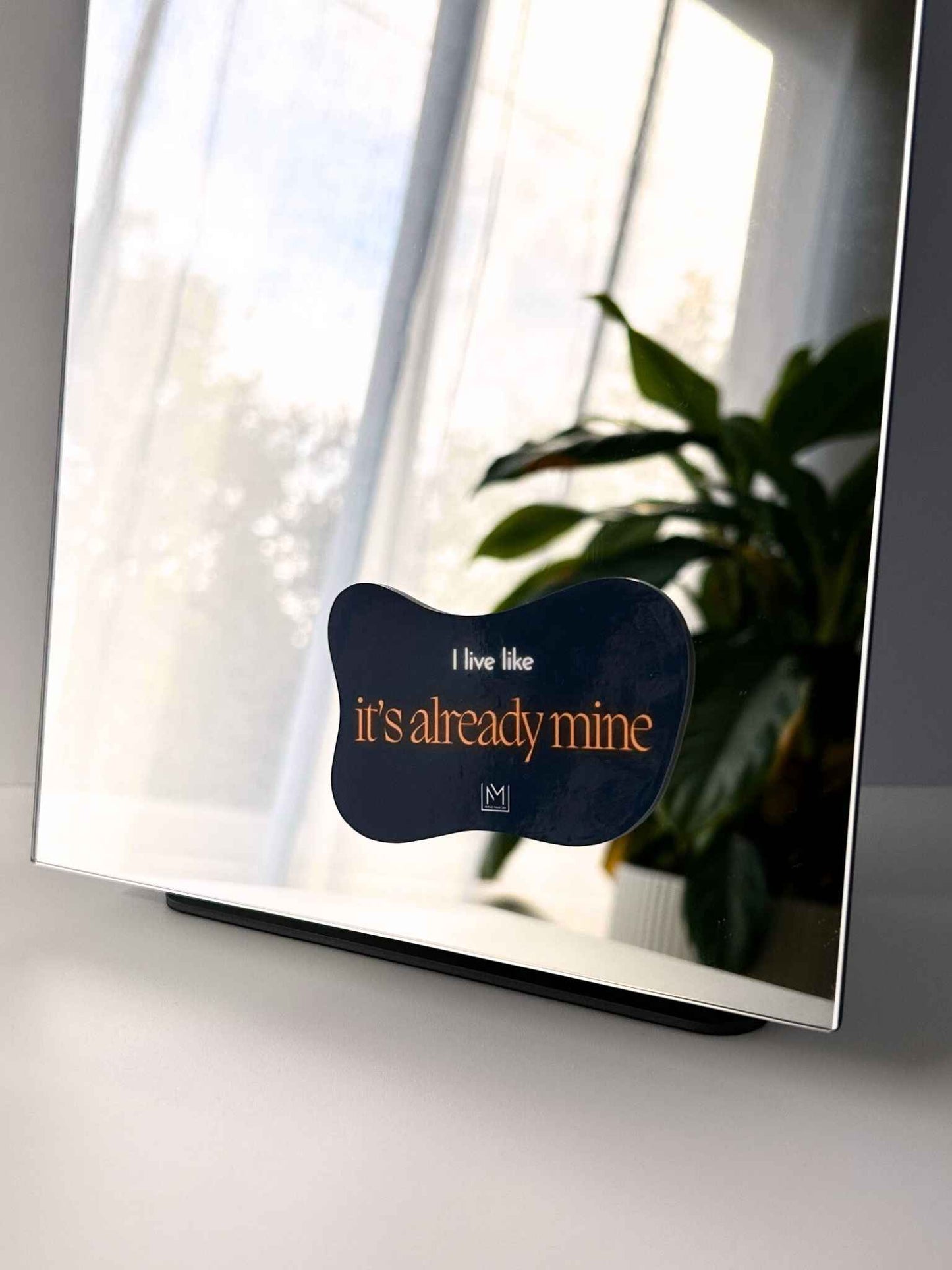 Bold mirror manifestation affirmation that reads “I live like it’s already mine”
