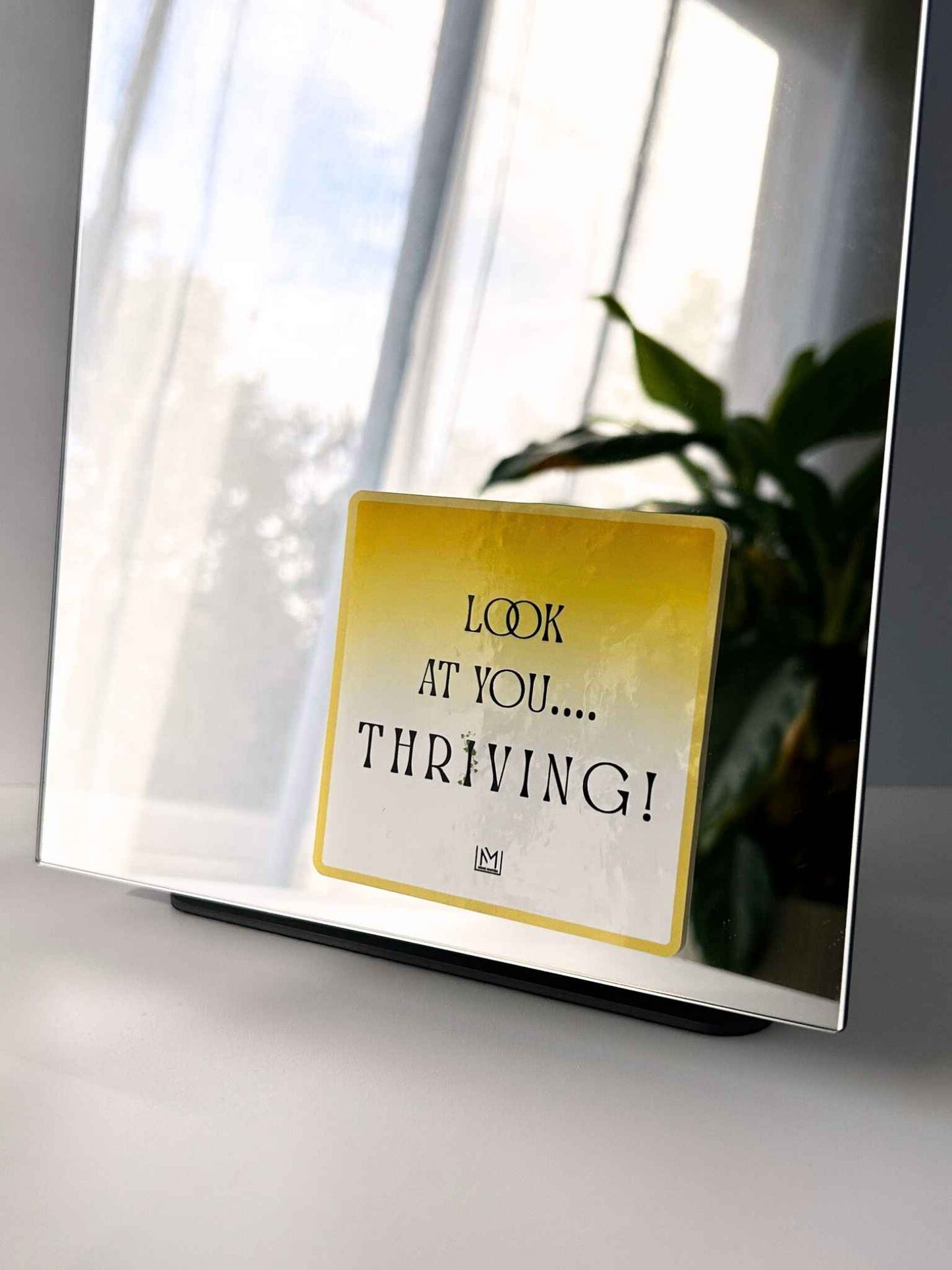 Yellow positive mirror affirmation sticker with “Look at you… thriving!”