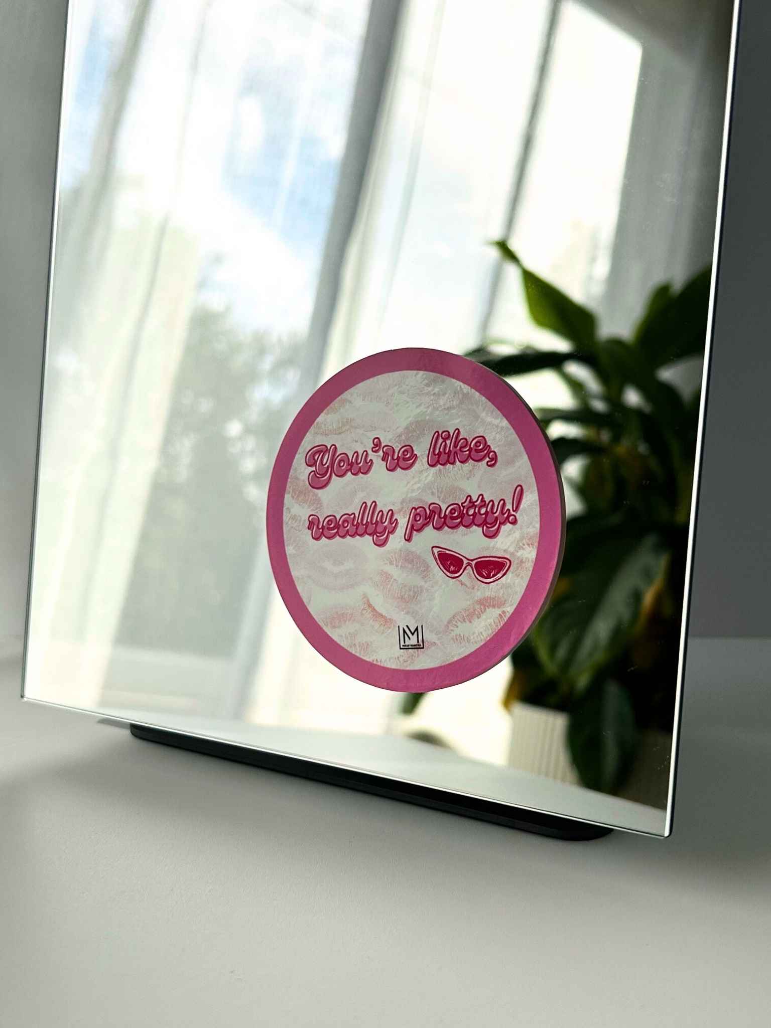 Circular self-love mirror sticker reading “You’re like, really pretty!” with sunglasses icon
